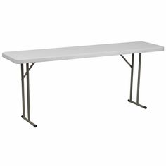 a white table sitting on top of a white floor next to a black metal frame