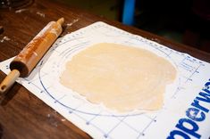 a wooden table with a rolling dough on it