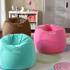 three bean bag chairs sitting on top of a rug