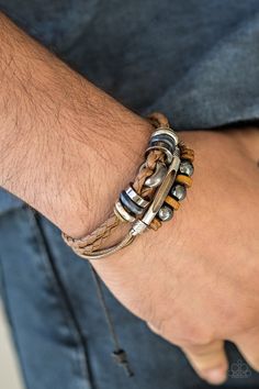 An array of metallic and wooden beads are knotted along mismatched strands of braided leather and shiny brown cording for a seasonal look. Features an adjustable sliding knot closure. Sold as one individual bracelet. P9UR-BNXX-420XX Adjustable Sliding Knot, Bohemian Style Men, Sliding Knot Closure, Coil Bracelet, Brown Leather Bracelet, Brown Bracelet, Silver Jewelry Necklace, Vintage Cowboy, Sliding Knot