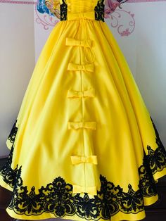 Gorgeous yellow satin dress  with multi layered skirt and train.Bodice and skirt are decorated   with black  lace.Back skirt is decorated with a lot of bows.Zipper and lacing back.Colors: Yellow and black.Petticoat included.Can be made any size. Ready to ship in 2-3 weeks. Yellow Ball Gown Dress For Debutante Ball, Yellow Ball Gown For Debutante Ball, Yellow Princess Wedding Gown, Yellow Ball Gown For Prom Season, Elegant Yellow Princess Dress For Wedding, Yellow Ball Gown For Pageant, Yellow Princess Style Party Gown, Elegant Yellow Princess Dress For Pageant, Yellow Floor-length Ball Gown For Party