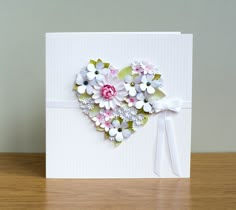 a heart shaped card with flowers on it