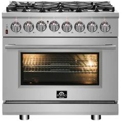 a stainless steel stove with four burners and two oven doors on each side, in front of a white background