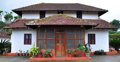 a house with potted plants in front of it