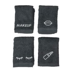 four pieces of black towels with eyelashes and eyes drawn on them, one has the word makeup