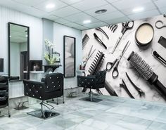 a hair salon with chairs, scissors and combs on the wall next to it