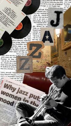 a man sitting on top of a red couch next to a wall covered in records