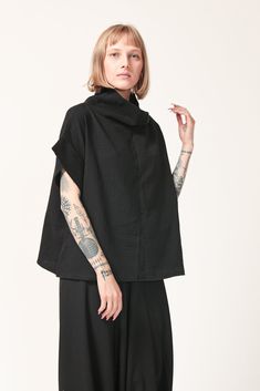 This beautiful and comfortable black oversize cowl neck top is a unique piece to have in any closet.  It has a stylish urban look and a loose fit.  The shirt is made from high quality cotton and can be worn both in summer and winter. This shirt can be paired with leggings, skinny jeans and a pencil skirt. Material: Cotton Sizes: Women's One Size  Measurements:  Height: 22.4"  Width: 44.4" Sleeve: 9.8"  Care instructions: - Turn garment inside out before washing - Hand wash in cold water separate Black Cowl Neck Top For Spring, Black Spring Cowl Neck Tops, Black Cotton Lagenlook Blouse, Lagenlook Short Sleeve Blouse For Fall, Black Boxy Top For Spring, Fall Lagenlook Blouse With Short Sleeves, Fall Lagenlook Short Sleeve Blouse, Oversized Black Tops With Funnel Neck, Black Short Sleeve Lagenlook Top