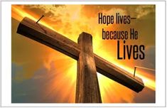 a wooden cross with the words hope lives because he lives above it in front of a sunset