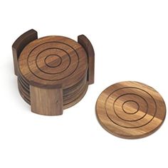 four wooden coasters with circles on the top and one has an arrow in the middle