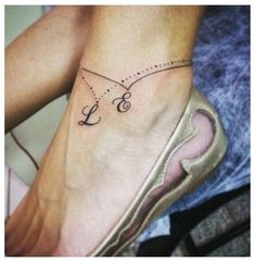 a woman's foot with a small tattoo on her left ankle and an anchor