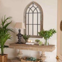 a living room filled with furniture and plants on top of a wooden table next to a mirror