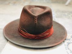 New in: Same Copper distressed Fedora Hat but accessorised with copper wire. Shades of brown and Copper touches. Wide Brim 6-7 cm or less if you wish so Hand sewing stitches Khaki trimming with copper splash Made to order,one of a kind Industrial ,Abstract look ¡!All my hats are perfectly flat and well stiff,the modern wayNo flip flop) I use Standard shipping ,please allow 14-17 business days for delivery. There are some delays with USPS in USA Customs,so please be patience with your order. Hand Sewing Stitches, Burned Hats, Mens Dress Hats, Black Fedora, Be Patience, Painted Hats, Boho Hat, Sewing Stitches, Shades Of Brown