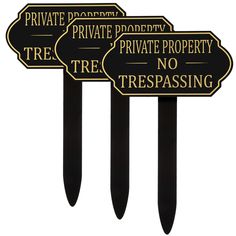 three black and gold private property signs on top of each other with the words trespassing