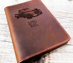 a brown leather wallet with an old truck on it