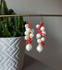 Handmade cluster earrings made with Freshwater Pearls, white color, and Red Coral branches. GOLD PLATED 925 STERLING SILVER Lenght : 5 cm / 1,97 inches * SHIPPING * Your order will be shipped within 1-3 business days from your purchase. You can choose between 2 shipping methods: STANDARD MAIL (NOT TRACEABLE) It is a cheap and fast shipping method, but NOT TRACEABLE. Chapeau Atelier is not responsible for any postal disruptions, delays or losses. REGISTERED MAIL (TRACEABLE) It is an absolutely sa Handmade Coral Jewelry For Party, Unique Dangle Pearl Earrings As Gift, Unique Dangle Pearl Earrings For Gift, Unique Handmade White Pearl Earrings, Handmade Coral Drop Earrings, Handmade White Dangle Cluster Earrings, Handmade White Pearl Earrings, Handmade Cluster Drop Earrings As Gift, Coral Jewelry Gift With Ear Wire