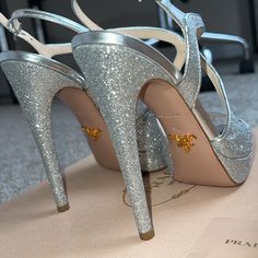 Description: Elevate Your Style With These Dazzling Prada Glitter Donna Short Platform Heels, A Statement Piece That Combines Luxury With Bold Fashion. Designed For Those Who Dare To Stand Out, These Heels Are A Testament To Prada’s Commitment To Craftsmanship And Avant-Garde Design. Key Features: Brand: Prada Size: Us 6 Condition: Brand New, Never Worn, And In Impeccable Condition, These Heels Come Ready To Add Sparkle And Sophistication To Your Wardrobe. Material: Full Glitter Embellishment, Offering A Stunning, Eye-Catching Appearance That Catches The Light With Every Step. Design: Elegantly Designed With A 6-Inch Heel And A Subtle Platform, Providing An Exqui Luxury Glitter Heels For Wedding, Designer Sparkling Heels For Formal Occasions, Luxury Open Toe Glitter Heels, Luxury Glitter Open Toe Heels, Designer Sparkling High Heels, Luxury Silver Glitter Heels, Luxury Glitter Heels With Round Toe, Luxury Glitter Accented Heels For Gala, Luxury Glitter Heels For Gala