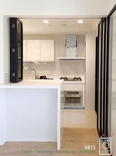 an empty kitchen with white walls and cabinets