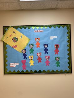 a bulletin board with children's faces on it