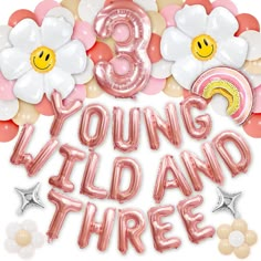 balloons and flowers are arranged around the words young wild and three