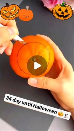 someone is cutting into an orange pumpkin with a sharp toothpick for halloween decorations