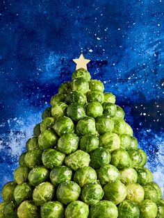 a christmas tree made out of brussel sprouts with a star on top