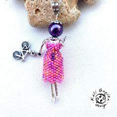 Beautiful cute vibrant beaded French doll pendant with bicycle charm. Beautiful Beaded Parisian vibrant pink and purple handmade french Doll pendant with bicycle charm is very cute and adorable. Handmade necklace designed by myself. This elegant  doll pendant made part of the Aida collection. Unique and designed by myself. Used high quality materials:  Miyuki Delica beads 11/0 Miyuki seed beads 15/0 Czech glass round bead 10 mm Stainless steel chain Violin key charm  Metal bead cup French doll b Handmade Pink Beaded Pendant Necklace, Handmade Pink Beaded Pendant Necklaces, Handmade Pink Pendant Beaded Necklaces, Handmade Necklace Designs, Doll Pendant, Metal Bead, French Dolls, Delica Beads, Pink Beads