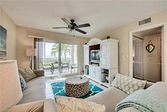 a living room filled with furniture and a flat screen tv