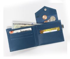 Now that you have a fabulous new handbag, it is time to update your wallet. This mini wallet holds all forms of money without taking up too much room. Easily store your cash and cards, and use the small little secret compartment for coins. The steel loop on the side can be easily attached to our key straps located inside your Ambrosia handbag for easy finding. Or attach our key loop strap to the mini wallet for when you are on the run and go! DETAILS Material: Genuine USA leather Measurements: 4 Blue Coin Purse With Card Slots For Gift, Blue Coin Purse With Card Slots For Personal Use, Blue Coin Purse With Card Slots, Blue Wallets With Rfid Blocking For Everyday Use, Blue Rfid Blocking Coin Purse For Daily Use, Blue Trifold Wallet With Rfid Blocking For Everyday Use, Blue Wallet With Rfid Blocking For Everyday Use, Blue Trifold Wallet With Coin Pocket, Blue Wallet With Card Slots As Gift