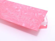 a pink plastic bag with the words army united states printed on it, sitting on a white surface