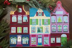 a paper doll house with christmas decorations and greenery