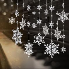 snowflakes hanging from strings in front of a piano