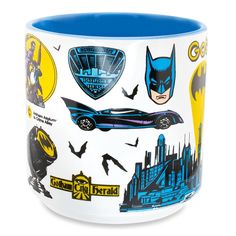 a batman mug with various stickers on it