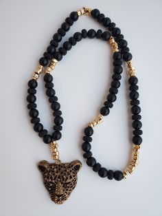 The Ghost of the Forest Necklace is made with Large 10mm Black Onyx Beads, gold spacers, and an eye catching black and gold panther pendant. Onyx crystals connect you with the realm of the night, where your true self can be found. Black onyx is a protection stone. Its purpose is to help prevent the drain of personal energy while at the same time absorbing and transforming negative energy DISCLAIMER: WE ARE NOT MEDICAL DOCTORS AND DO NOT WORK IN THE MEDICAL FIELD. WE MAKE NO CLAIMS REGARDING MEDI Gold Onyx Beaded Necklaces With Black Beads, Gold Beaded Necklace With Black Onyx Beads, Gold Onyx Beaded Necklace With Black Beads, Adjustable Black Necklace With Gold Beads, Spiritual Gold Necklace With Black Beads, Panther Necklace, Forest Necklace, Onyx Crystal, Personal Energy