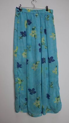 "a vintage sheer blue and yellow floral button-down midi-skirt with a knee-length underskirt ✿ IMPORTANT INFORMATION: * good vintage condition - rip pictured (price reduced) * size: medium - please check exact measurements below (they're there for your benefit!) ✿ MEASUREMENTS (taken while item is lying flat, some measurements will need to be doubled): * length: 38\" (97cm) * waist: 13.5-16\" (34-41cm) - elasticated * hips: 23\" (58cm) ✿ free UK shipping on orders over £100 with code STRAWBERRY Blue Floral Midi Skirt, Retro Blue Midi Skirt, Blue Lined Vintage Skirt, Blue Floral Print Knee-length Skirt, Retro Blue Floral Print Skirt, Floral Midi Skirt, Vintage Button, Skirt, Yellow Floral