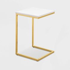 a small white and gold side table on a white background, with the top off