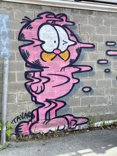 a pink cat painted on the side of a building