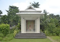 a small white building with steps leading up to it