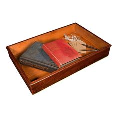 three books in a wooden box on a white background