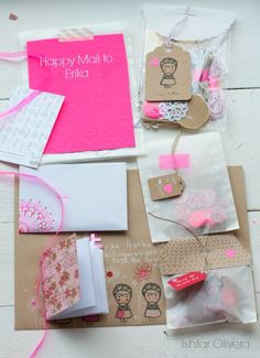 many different types of greeting cards and envelopes on a white wooden table with pink ribbon