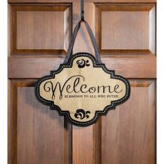 a welcome sign hanging on the front door