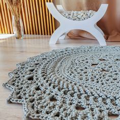 there is a crocheted rug on the floor