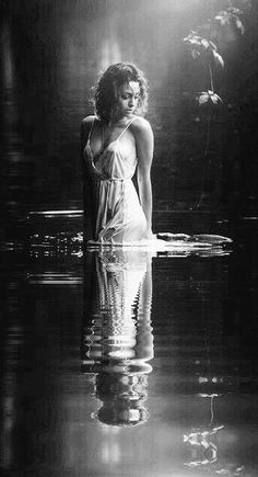 a woman is standing in the water