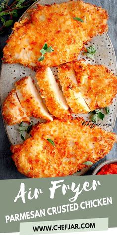 grilled chicken with parmesan crusts on a platter and garnished with herbs