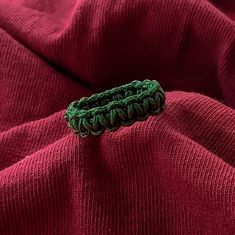 a green piece of cloth sitting on top of a red blanket