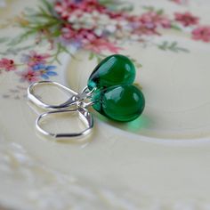 These gorgeous little drop earrings have stunning dark green teardrop beads suspended from silver leverback earring wires.The green tear drop beads in these earrings are beautiful - a clear shade of deep forest green. They are high quality Czech glass, with a lovely glossy finish.They are suspended from silver-plated leverback hooks. Your earrings will arrive presented in a pretty little box tied with ribbon, ready to give as a gift. A sample of packaging is shown in the last photo.⬇︎ Size and s Green Teardrop Earrings As Gift, Dark Green Drop Earrings As Gift, Green Teardrop Earrings For Jewelry Making, Green Teardrop Drop Earrings For Jewelry Making, Elegant Green Hypoallergenic Teardrop Earrings, Green Teardrop Earrings For Gift, Green Teardrop Drop Earrings Nickel Free, Green Teardrop Earrings With Ear Wire For Gift, Green Teardrop Pierced Earrings For Gift