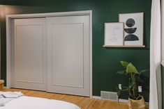 a bedroom with green walls and white doors