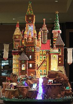 an elaborate gingerbread castle with lights and decorations