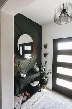 a black and white entryway with a mirror on the wall