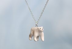 This little polar bear necklace is the perfect accessory for any bear lover! This pendant is about 1 inch wide and comes on a 22 inch silver plated chain.  This piece is handmade by myself, Anna, in my small home pottery studio, alongside everything else in the shoppe. The figurine is hand sculpted, hand glazed, and fired by myself in my studio.  Because all of my pieces are handmade, there will be variances between all pieces, be it color, size, or general looks. My pottery style embraces the natural aesthetic imperfections found in the craft to give my pieces a genuine, handmade feel. Colors may appear slightly different in person due to lighting, camera, and tablet/computer screen variances. Home Pottery Studio, Cottagecore Necklace, Bear Jewelry, Jewelry Cute, Necklace Cute, Bear Figurine, Bear Necklace, Pottery Studio, Handmade Ceramic